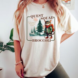 quest squad tee
onyx storm cozy
broccoli kitten team
dragon rider
dragon riders tee
xaden quadrant shirt
fourth wing merch
rebecca yarros
the empyrean series
onyx shirt
storm quest t-shirt
broccoli graphic tee
quest team shirt