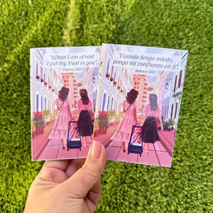 May include: Two women walking down a street with suitcases. The text on the card reads "When I am afraid I put my trust in you." Psalms 56:3