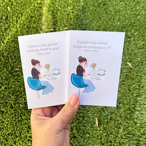May include: Two white cards with a blue and white illustration of a woman sitting in a blue chair reading a book. The text on the cards reads "When I am afraid I put my trust in you." Psalms 56:3 and "Cuando tengo miedo pongo mi confianza en ti" Salmos 56:3.