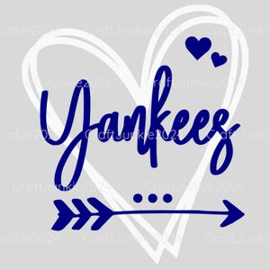 May include: A blue and white graphic design with the word "Yankees" in a cursive font inside a white heart with two small hearts above it. A blue arrow with three points is below the heart.