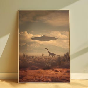 May include: A framed art print depicts a surreal desert landscape. A Brontosaurus walks across the foreground, with a UFO hovering in the sky. The color palette is muted, with browns, tans, and blues dominating the scene.