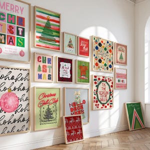May include: A collection of framed Christmas-themed art prints. The prints feature festive designs, including Christmas trees, ornaments, and holiday greetings. The color palette includes red, green, and white, with some prints incorporating text.