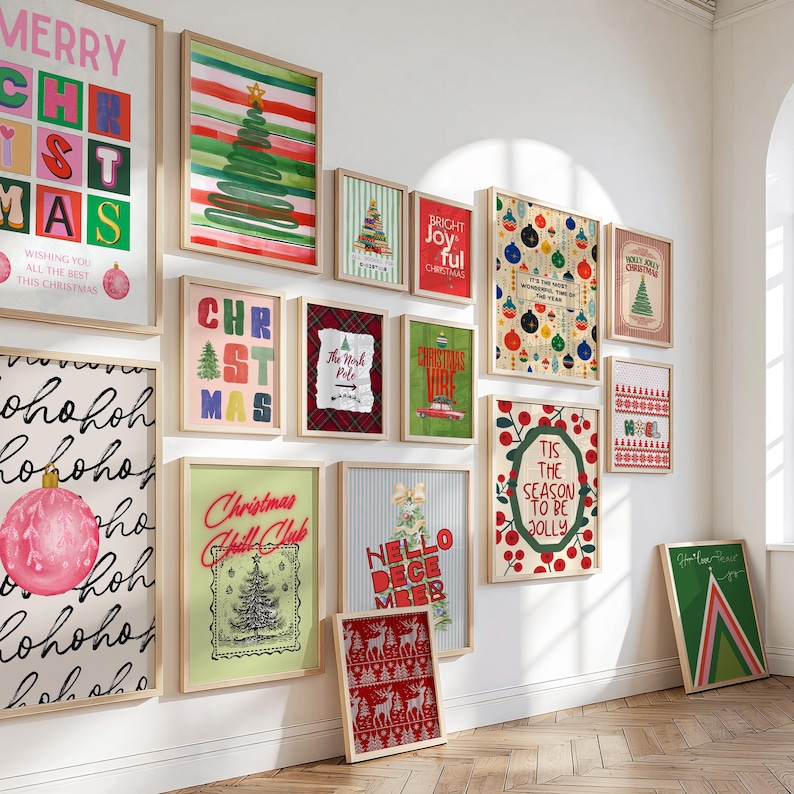 May include: A collection of framed Christmas-themed art prints. The prints feature festive designs, including Christmas trees, ornaments, and holiday greetings. The color palette includes red, green, and white, with some prints incorporating text.