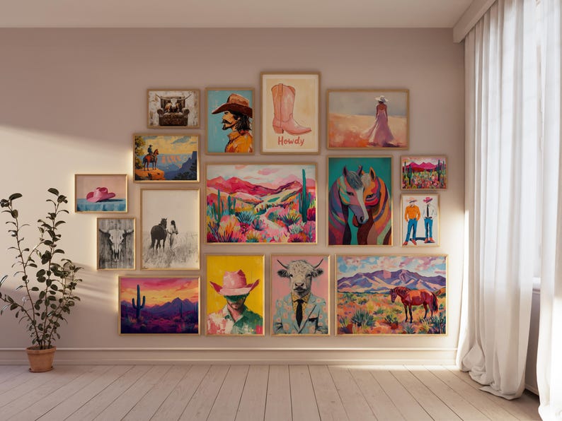 May include: A gallery wall featuring a variety of framed artwork, including paintings of horses, cowboys, landscapes, and abstract designs. The wall is painted a light beige color and the frames are all different sizes and colors.