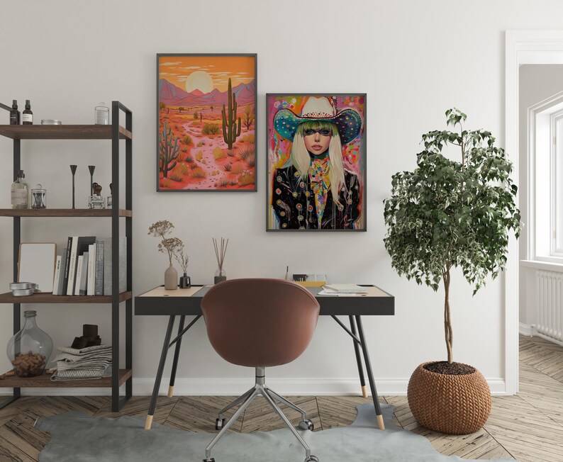 May include: A framed print of a woman wearing a colorful cowboy hat and a black jacket with a desert landscape in the background. The print is hanging on a white wall above a desk with a brown chair.