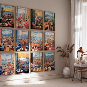 May include: A collection of twelve framed art prints, each depicting a vibrant city scene viewed from a balcony or interior space. The prints feature colorful floral arrangements, furniture, and city names like Bombay and Taipei.