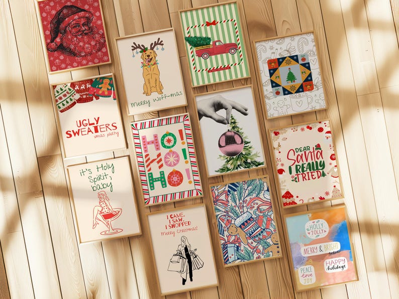 May include: A collection of framed Christmas-themed art prints. The prints feature festive illustrations, including Santa Claus, a dog with antlers, a red truck with a Christmas tree, and the text "Ugly Sweaters xmas party."