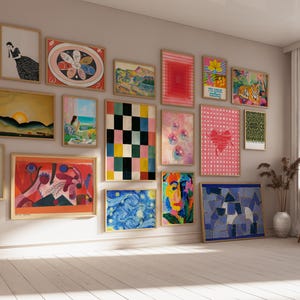 May include: A gallery wall featuring a collection of framed art prints in various sizes and orientations. The display includes abstract, landscape, and figurative illustrations in a diverse color palette, arranged in a grid-like pattern on a wall.