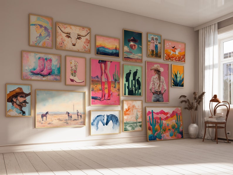 May include: A gallery wall featuring a variety of framed artwork with a western theme. The artwork includes images of cacti, horses, cowboys, boots, and a bull's head. The artwork is displayed on a white wall in a room with a wooden floor.