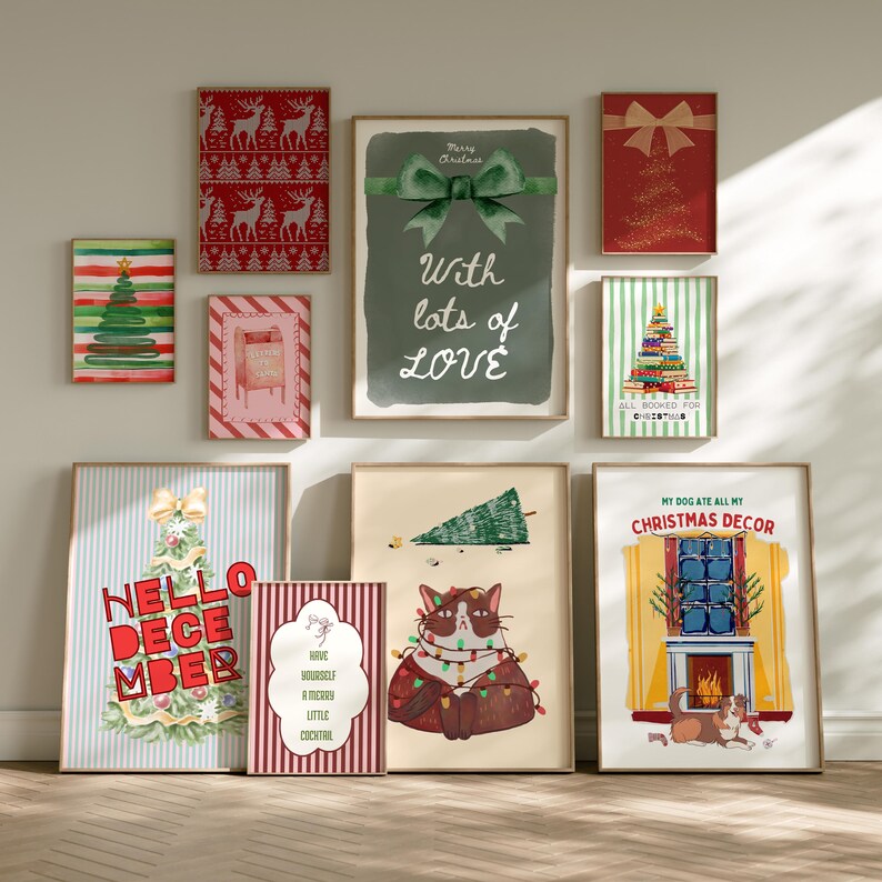 May include: A collection of framed Christmas-themed art prints. The prints feature various designs, including Christmas trees, a cat with lights, and festive text like "Hello December" and "My Dog Ate All My Christmas Decor."