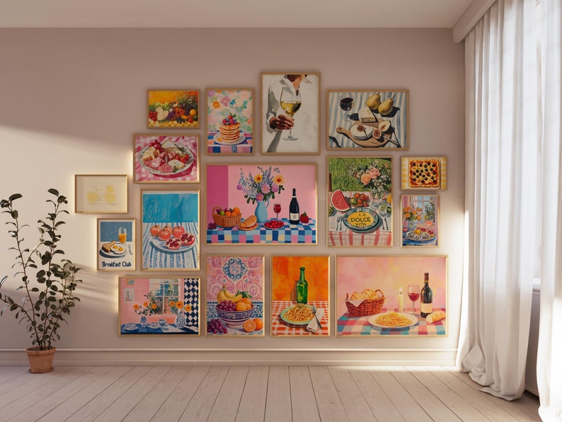 May include: A gallery wall of framed artwork featuring various still life paintings of food and drink. The paintings are in a variety of styles and colors, and they are arranged in a grid pattern on a light beige wall. The paintings include a still life of fruit, a still life of pasta, a still life of wine, and a still life of bread.