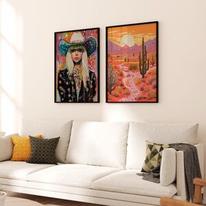 May include: Two framed art prints, one featuring a woman wearing a colorful cowboy hat and the other depicting a desert landscape with a tall cactus.