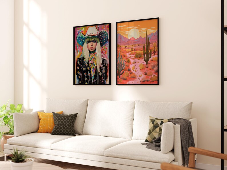 May include: Two framed art prints, one featuring a woman wearing a colorful cowboy hat and the other depicting a desert landscape with a tall cactus.