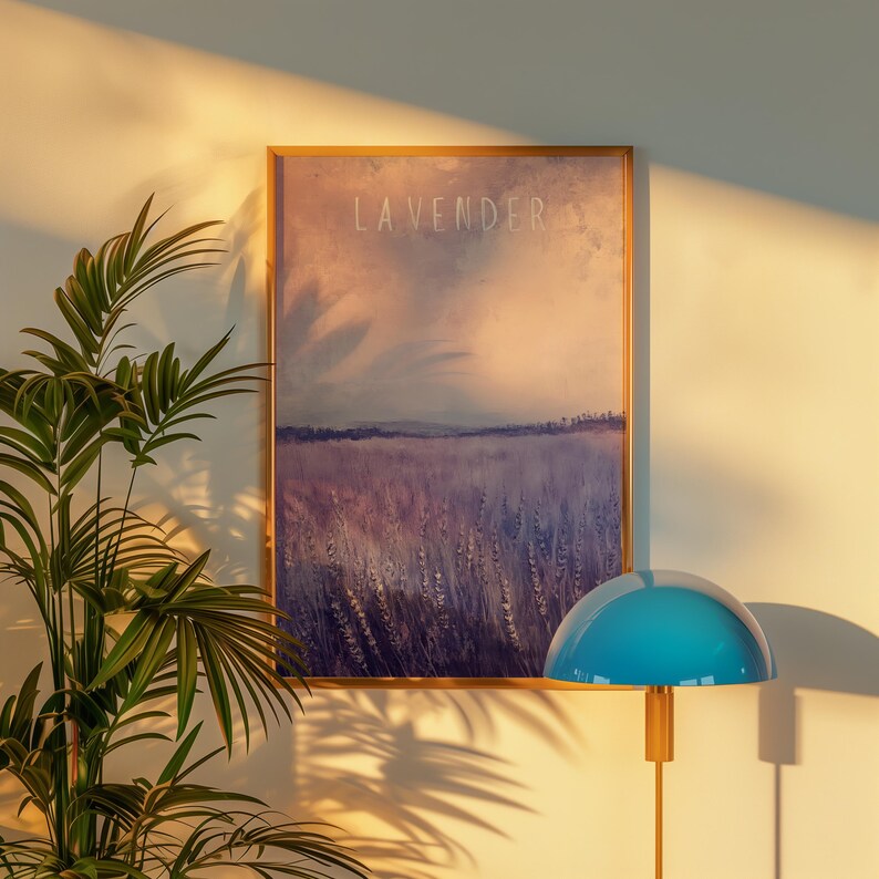 May include: A framed print of a watercolor painting depicting a field of lavender flowers. The painting is titled "Lavender" and has a soft, dreamy aesthetic. The print is displayed on a white wall with a blue lamp in the foreground.