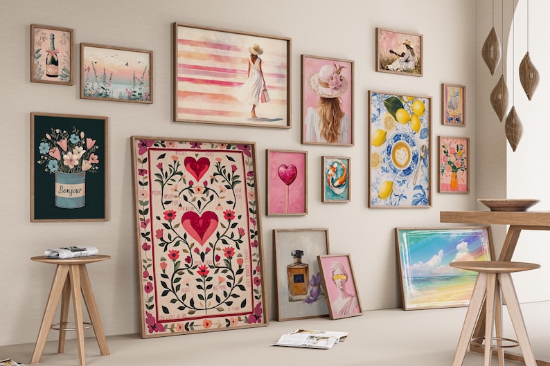 May include: A gallery wall arrangement featuring various framed art prints including a large central poster with red hearts and floral motifs, a print of lemons and coffee, a woman in a white dress, a perfume bottle, and a bouquet in a blue bucket.