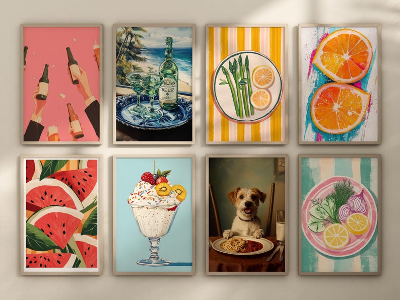 May include: A set of nine framed prints featuring various images, including a bottle of wine, a plate of asparagus, a bowl of fruit, a plate of watermelon, a bowl of ice cream, a dog, and a plate of vegetables. The frames are all white and have a simple design.