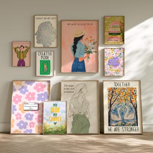 May include: A selection of framed art prints with diverse designs and motivational quotes. The prints showcase illustrations of figures, flowers, and abstract patterns in various colours, including pink, blue, and green. Some prints feature text such as "Thoughts Are Not Facts" and "My Body My Choice."