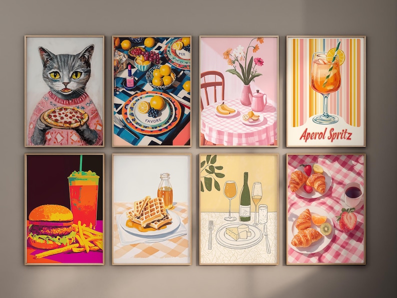 May include: A set of nine framed prints featuring various food and drink illustrations. The prints are in a modern style with bright colors and bold lines. The prints include a cat eating pizza, a plate of waffles, a glass of Aperol Spritz, and a table setting with fruit and flowers.