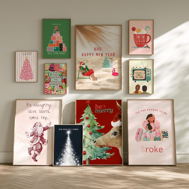 May include: A collection of framed Christmas-themed art prints. The prints feature festive illustrations, including a Christmas tree made of presents, Santa Claus, a reindeer, and humorous text like "Broke" and "Be Naughty."
