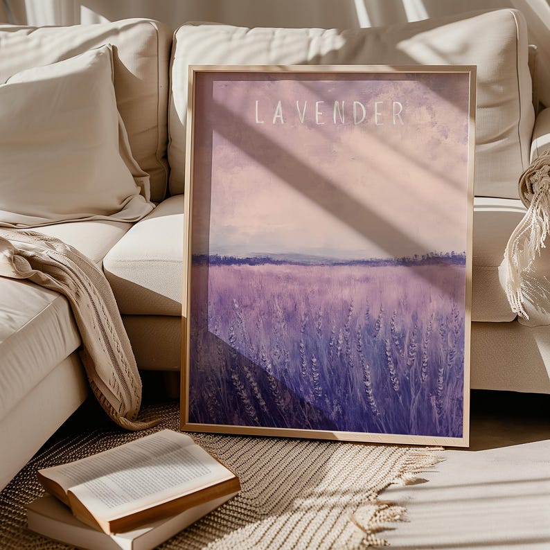 May include: A framed print of a lavender field with the word "LAVENDER" in white text at the top. The field is a soft purple color with a light pink sky in the background.