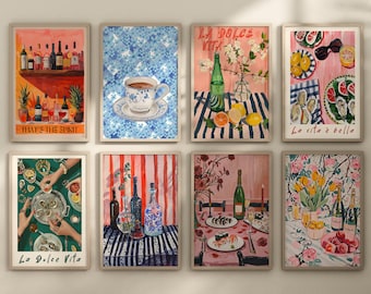 May include: A set of eight framed prints with various illustrations, including a still life of wine bottles, a cup of tea, a floral arrangement, and a plate of oysters. The prints are all in a similar style, with a colorful and whimsical aesthetic. The text on the prints includes "That's the Spirit", "La Dolce Vita", and "La vita è bella".