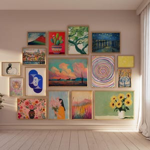 May include: A gallery wall with a variety of framed artwork, including abstract paintings, landscapes, and still lifes. The artwork is arranged in a grid pattern on a light pink wall.