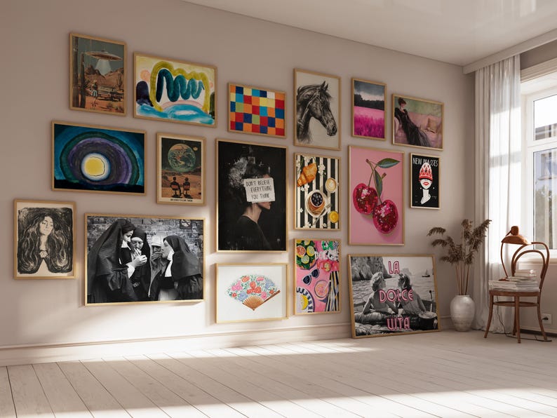 May include: A gallery wall with a variety of framed artwork, including abstract paintings, illustrations, and photographs. The artwork features a mix of colors, patterns, and styles, creating a vibrant and eclectic display.