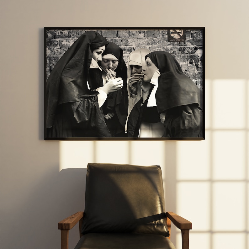May include: Black and white photograph of four nuns standing in front of a brick wall. They are all wearing traditional habits and are smoking cigarettes. A no smoking sign is visible in the background.