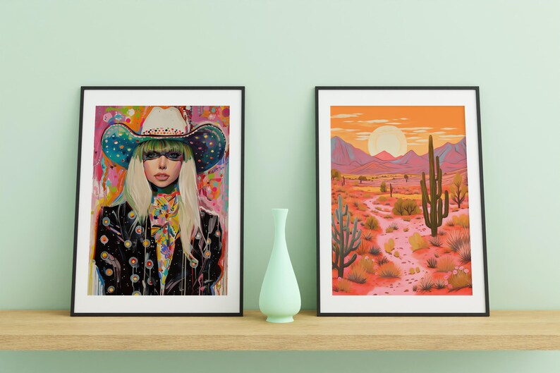May include: Two framed art prints, one featuring a woman wearing a colorful cowboy hat and the other depicting a desert landscape with a tall cactus.