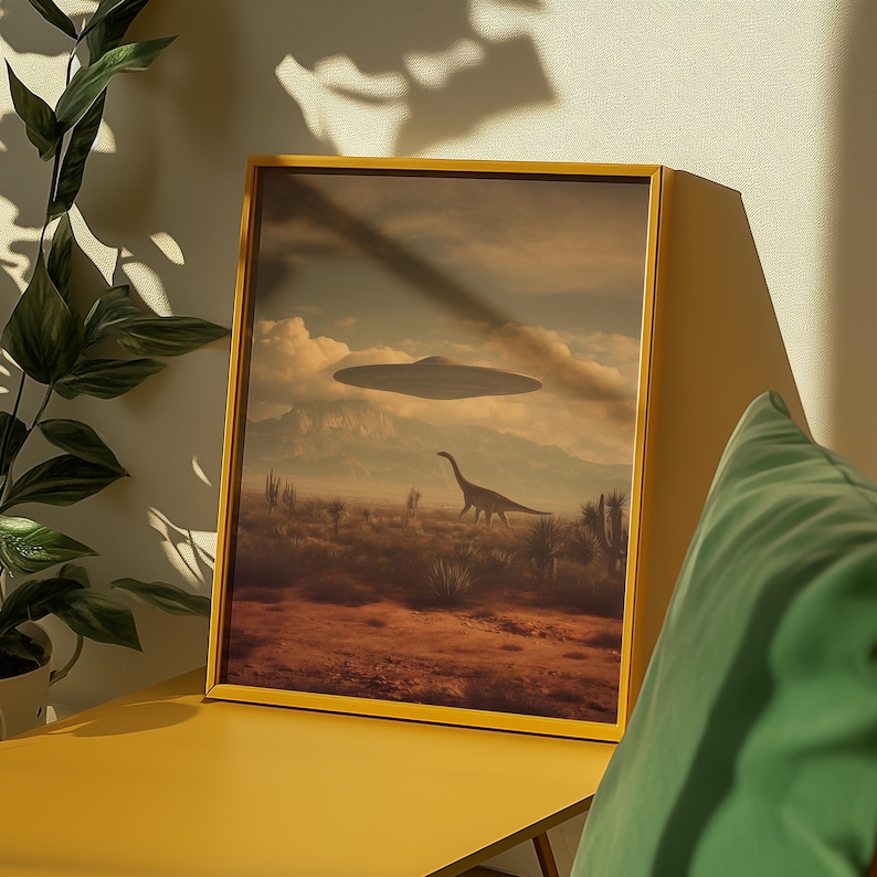 May include: A framed art print featuring a surreal landscape with a dinosaur and a UFO hovering in the sky. The artwork has a yellow frame and depicts a desert scene with mountains in the background. The color palette includes shades of brown, beige, and blue.