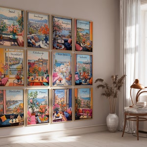 May include: A collection of framed art prints featuring watercolor illustrations of cityscapes. Each print showcases a different city, with vibrant colors and detailed depictions of balconies and floral arrangements. The prints are displayed on a neutral wall.