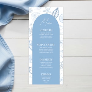 May include: A pale blue menu card with a white background and seashell illustrations. The menu includes sections for starters, main course, desserts, and drinks. The menu text is in a handwritten style font.