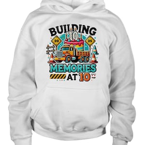 May include: White hoodie with a graphic of a construction truck and a birthday cake with the text "Building Memories at 10".