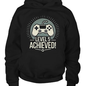 May include: Black hooded sweatshirt with a graphic of a video game controller and the text "Level 5 Achieved!"