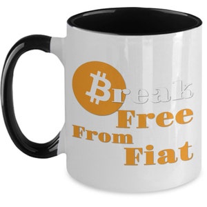 May include: White ceramic mug with a black handle and black rim. The mug has an orange Bitcoin symbol and the text "Break Free From Fiat" in orange.
