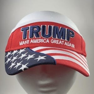 May include: A red, white, and blue baseball cap with a white brim and a blue and white American flag design on the front. The cap has the text "TRUMP MAKE AMERICA GREAT AGAIN" embroidered on the front.
