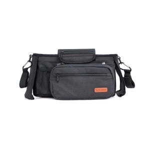May include: A black stroller organizer bag with multiple compartments and pockets. The bag has a main compartment, a smaller zippered pouch, and a mesh pocket. It includes a detachable shoulder strap and a small brown label.