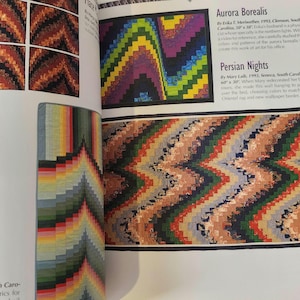 May include: A page from a book featuring colorful quilt designs. One quilt has a zig-zag pattern with shades of green, yellow, purple, and blue. Another quilt has a similar pattern with brown, orange, and green hues.