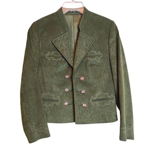 May include: An olive green jacket with a textured finish, featuring a double-breasted front with six buttons. The garment includes a stand-up collar and decorative light-colored embroidery detailing on the lapels, chest, and sleeve cuffs.