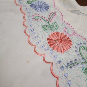 May include: A white ceramic mug with a black handle and the text "But First, Coffee" in a black, bold font. The mug is on a white surface. The mug is approximately 4 inches tall.