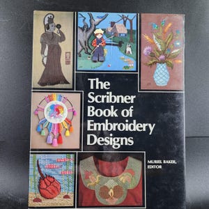 May include: A hardcover book titled "The Scribner Book of Embroidery Designs" with various embroidery designs on the cover. The cover features a variety of colorful embroidered images, including a figure, a fishing scene, and floral arrangements.