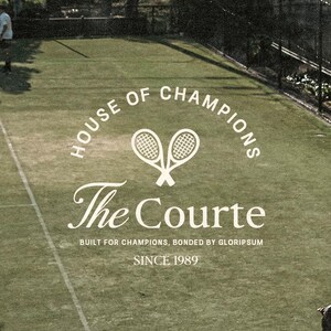 May include: An outdoor tennis court with the text "HOUSE OF CHAMPIONS" and "The Courte" in white. Two tennis rackets are crossed above the text. The text "SINCE 1989" is also visible. Two people are on the court.