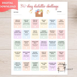 May include: A 30-day declutter challenge printable sheet featuring a grid of thirty tasks with checkboxes. The header reads 30-day declutter challenge above a brown box icon. Each task is color-coded in pastel shades of pink, blue, yellow, and green.