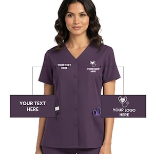 May include: A short-sleeved, purple medical scrub top with a V-neck and button-up front. The scrub top has two pockets and a small logo with a stethoscope and heart. The text "YOUR TEXT HERE" and "YOUR LOGO HERE" are displayed.