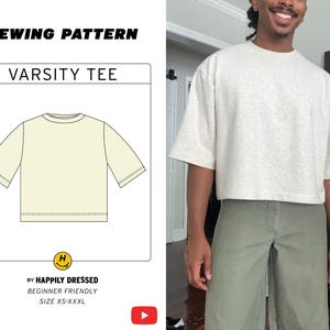 May include: A sewing pattern for a Varsity Tee is displayed next to a person wearing a similar shirt. The pattern includes a diagram of the tee and the text "Varsity Tee" and "By Happily Dressed". The person is wearing a light gray tee and olive green pants.