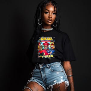 May include: Black t-shirt with a graphic design featuring a child in a graduation cap and gown, surrounded by Sonic the Hedgehog characters. The text "GRAD" and "TYREN" are also included in the design.