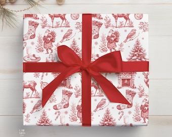 May include: A square gift box wrapped in white paper with a red toile-style Christmas pattern featuring Santa Claus, reindeer, stockings, birds, and trees. A wide, solid red satin ribbon is tied in a large bow across the center.