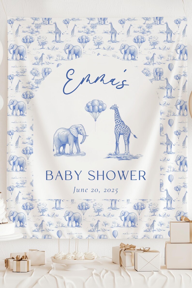 May include: A white fabric banner featuring a blue toile-style pattern of elephants, giraffes, and balloons. The center displays the text "Emma's BABY SHOWER June 20, 2025" with a central illustration of an elephant, a giraffe, and a cluster of balloons.