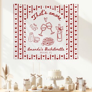 May include: Red and white bachelorette party banner with the text "That's amore" and "Amanda's Bachelorette Miami, FL" surrounded by hearts and stripes.