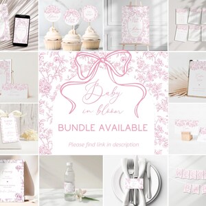 May include: A collection of baby shower decorations in pink and white, including invitations, cupcake toppers, table cards, and a banner that reads "WELCOME BABY." The design features floral patterns and the text "Baby in bloom."